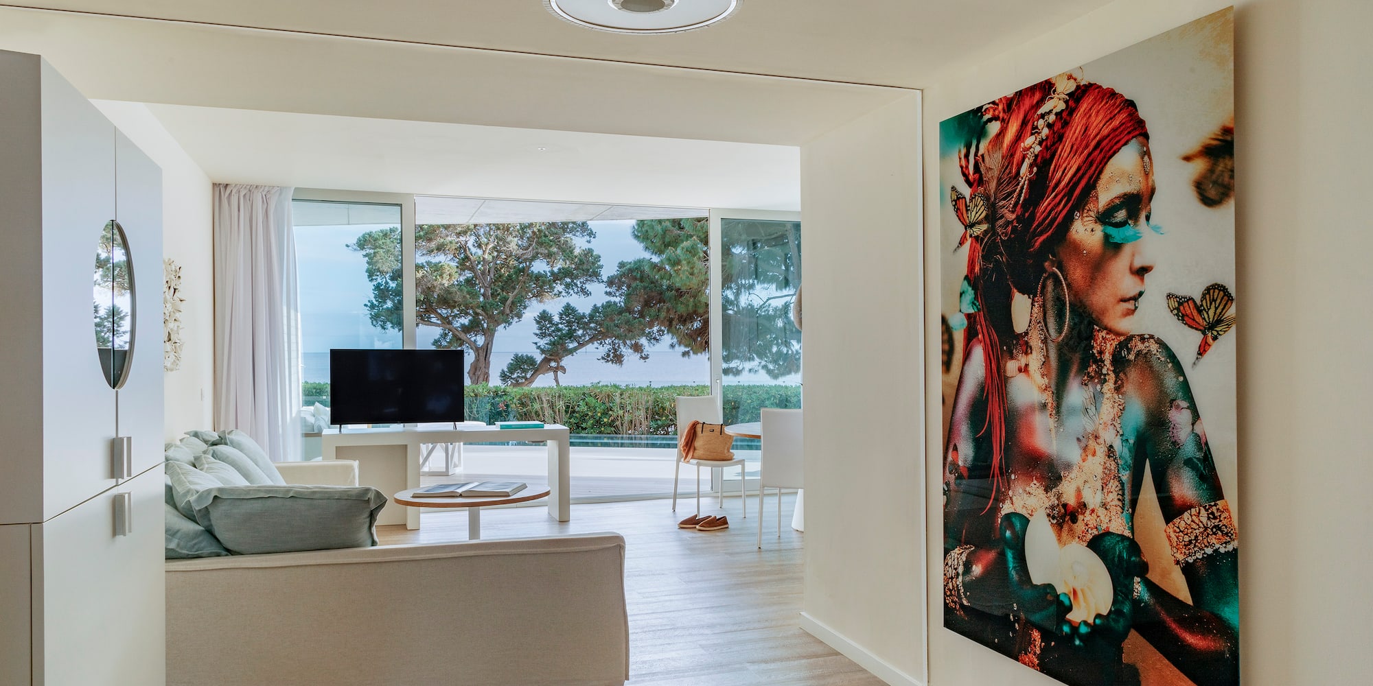 a living room with a large painting on the wall