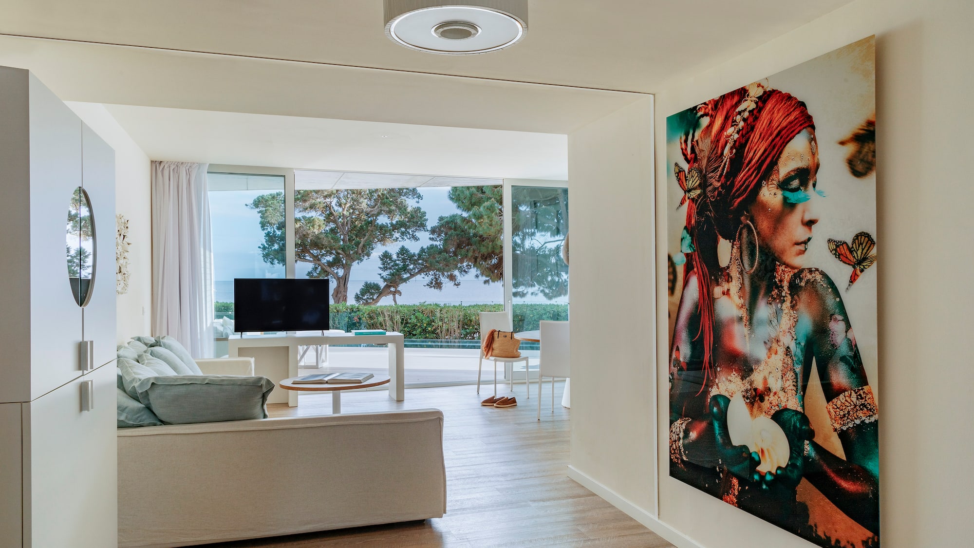 a living room with a large painting on the wall