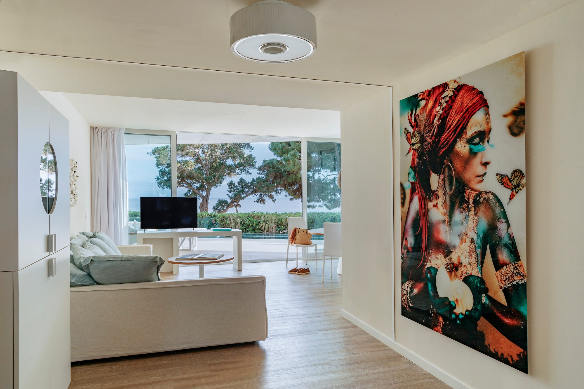 a living room with a large painting on the wall