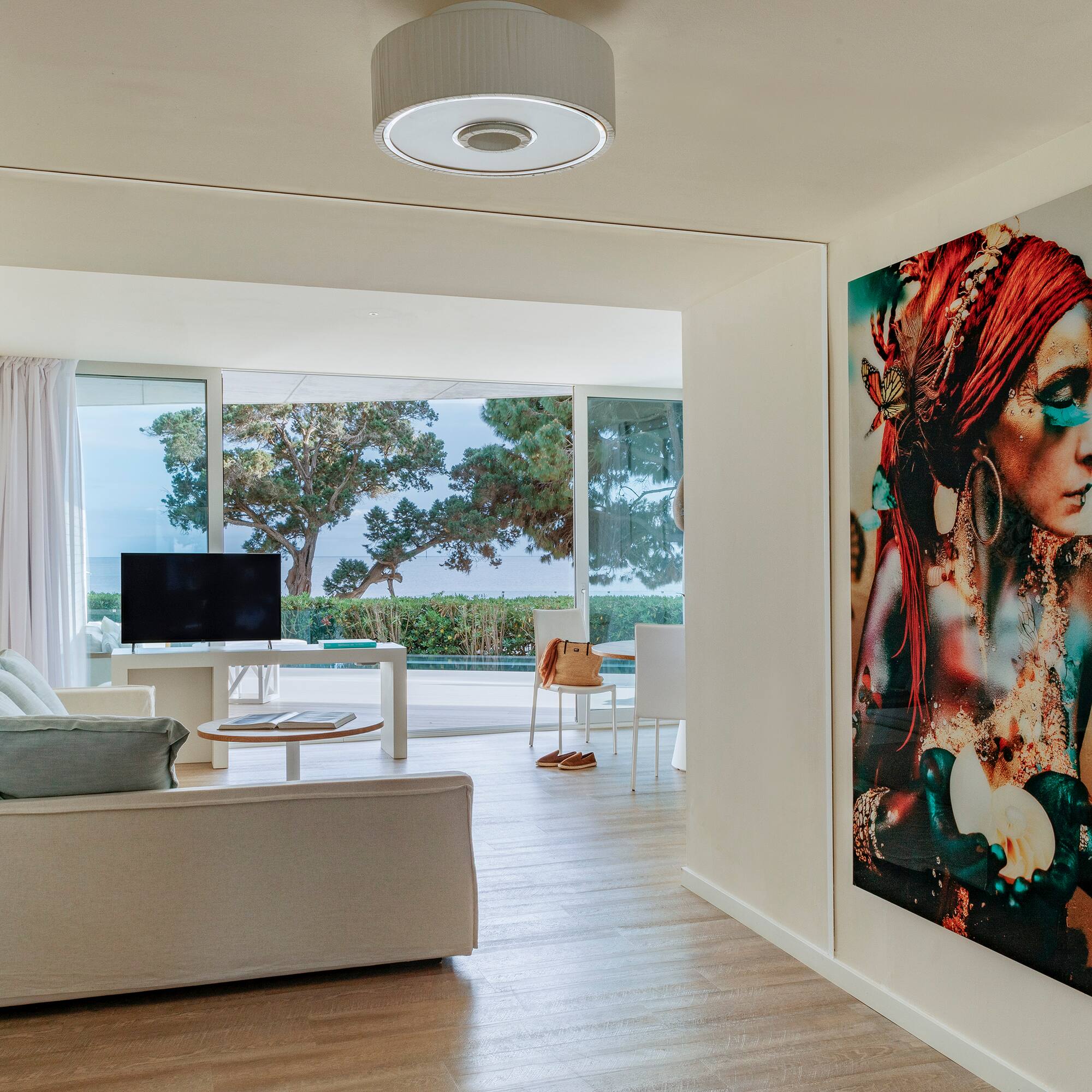 a living room with a large painting on the wall