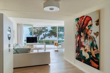 a living room with a large painting on the wall