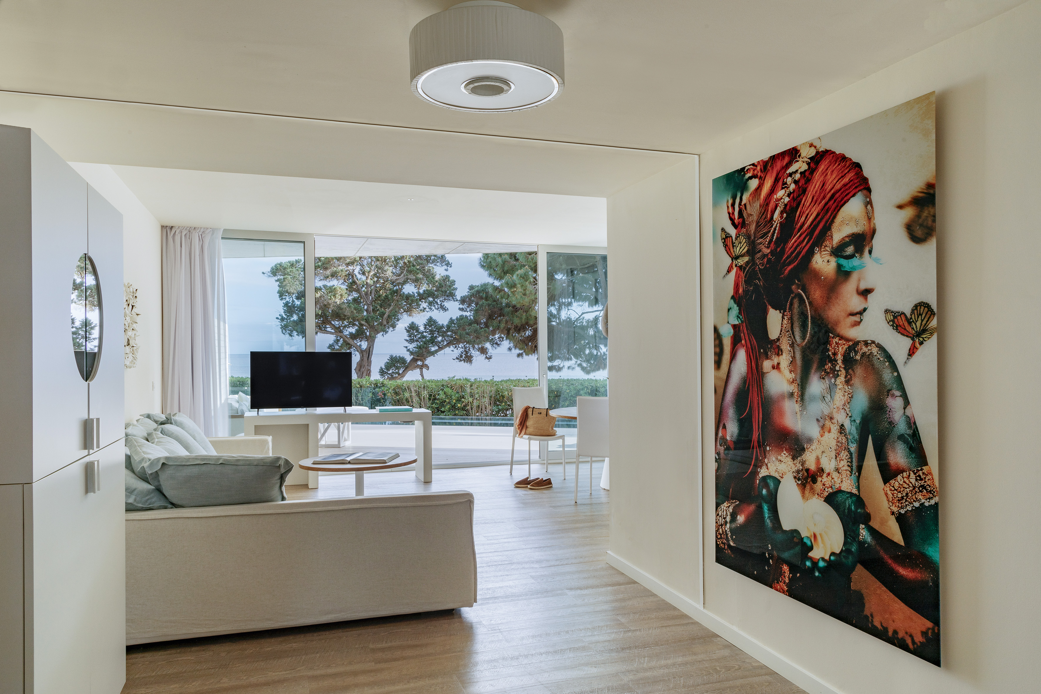 a living room with a large painting on the wall