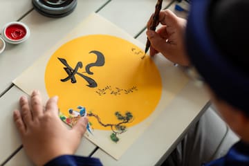 a person writing on a piece of paper