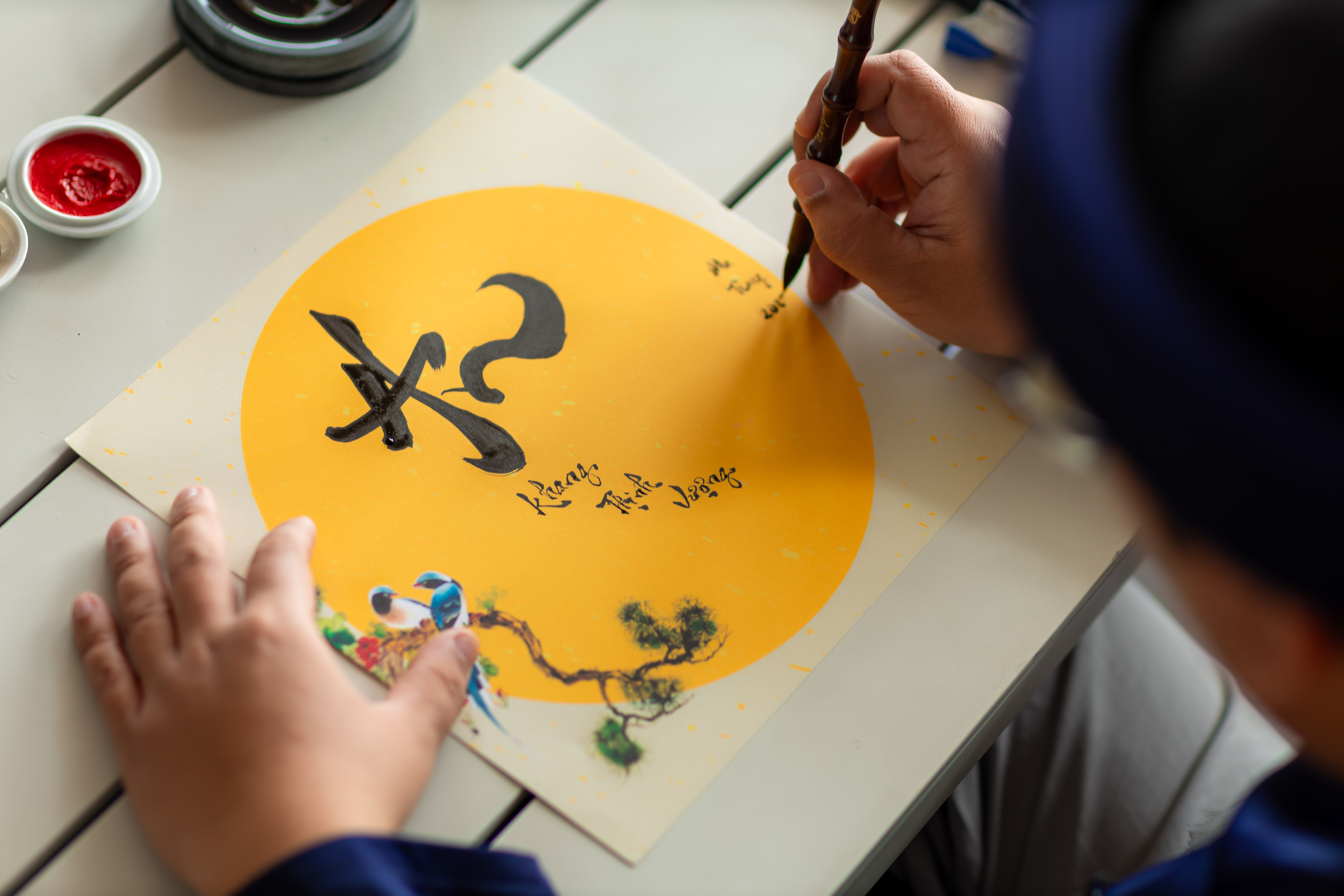 a person writing on a piece of paper