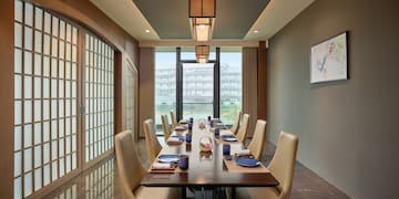 a dining room with a table and chairs