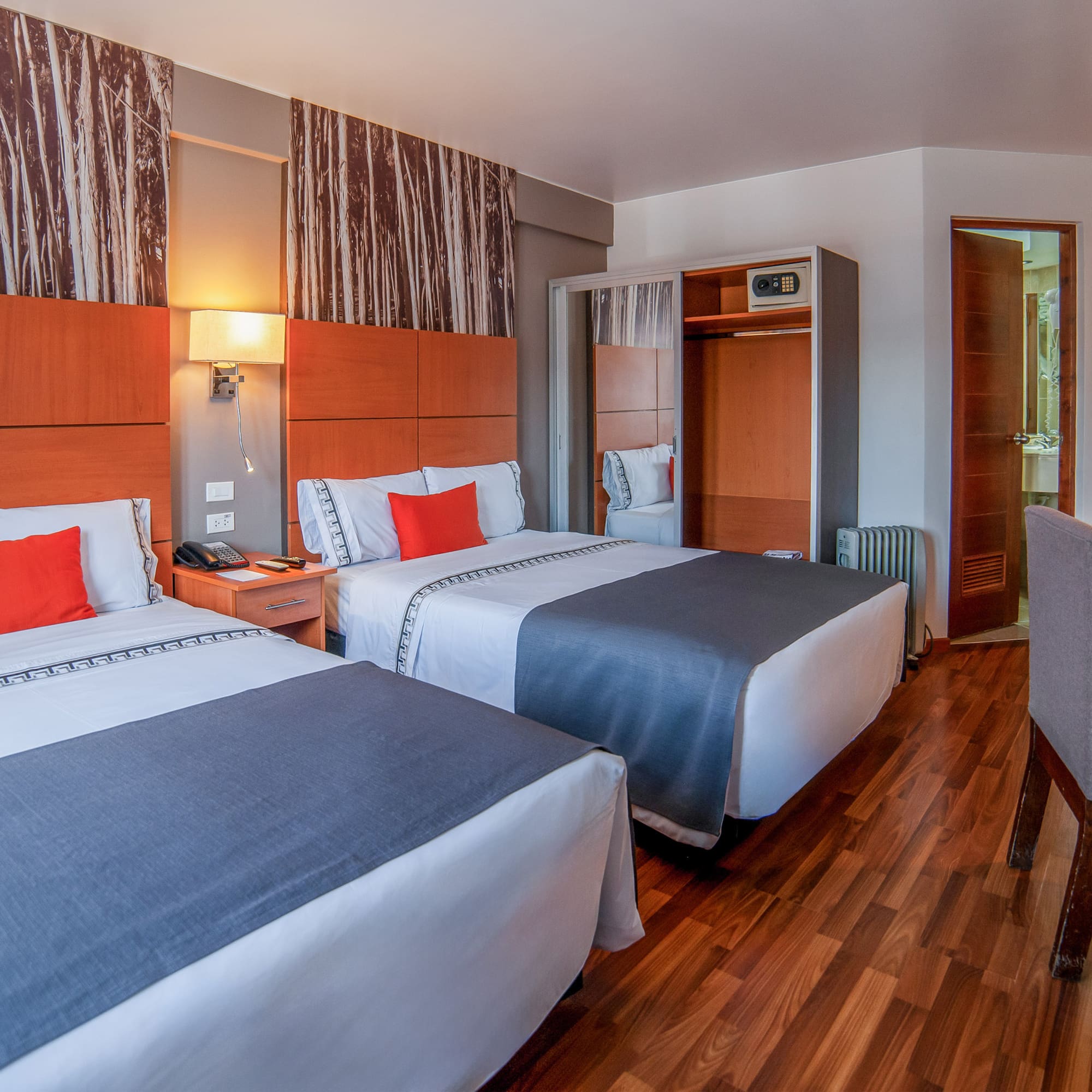a room with two beds and a wood floor
