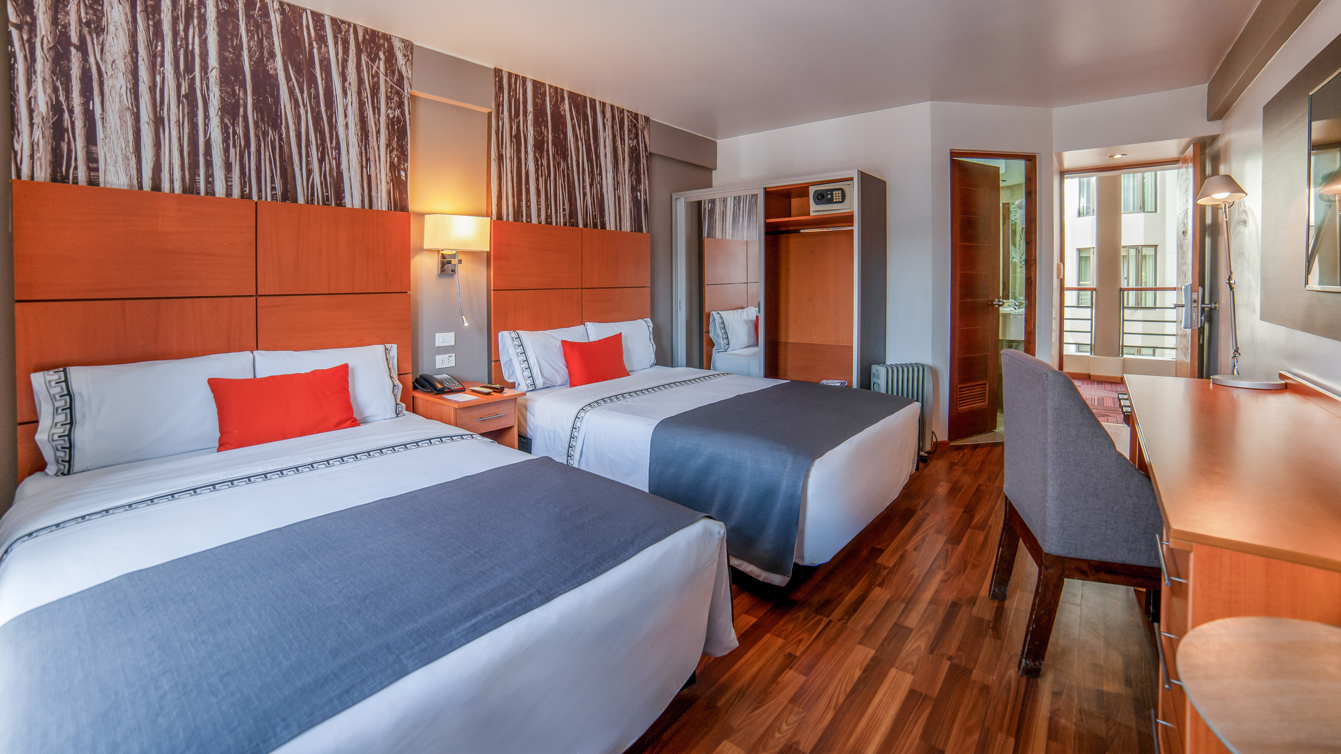 a room with two beds and a wood floor
