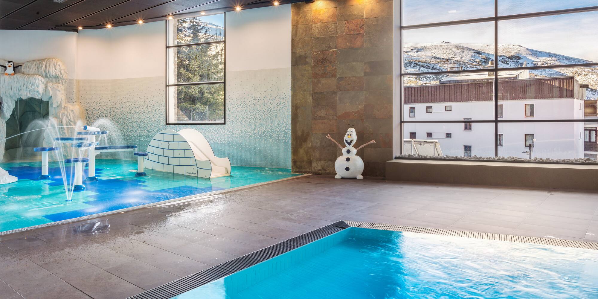 a indoor pool with a slide and a snowman