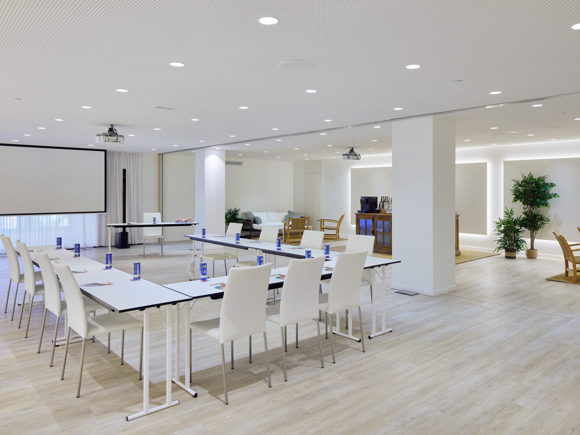 a room with white tables and chairs