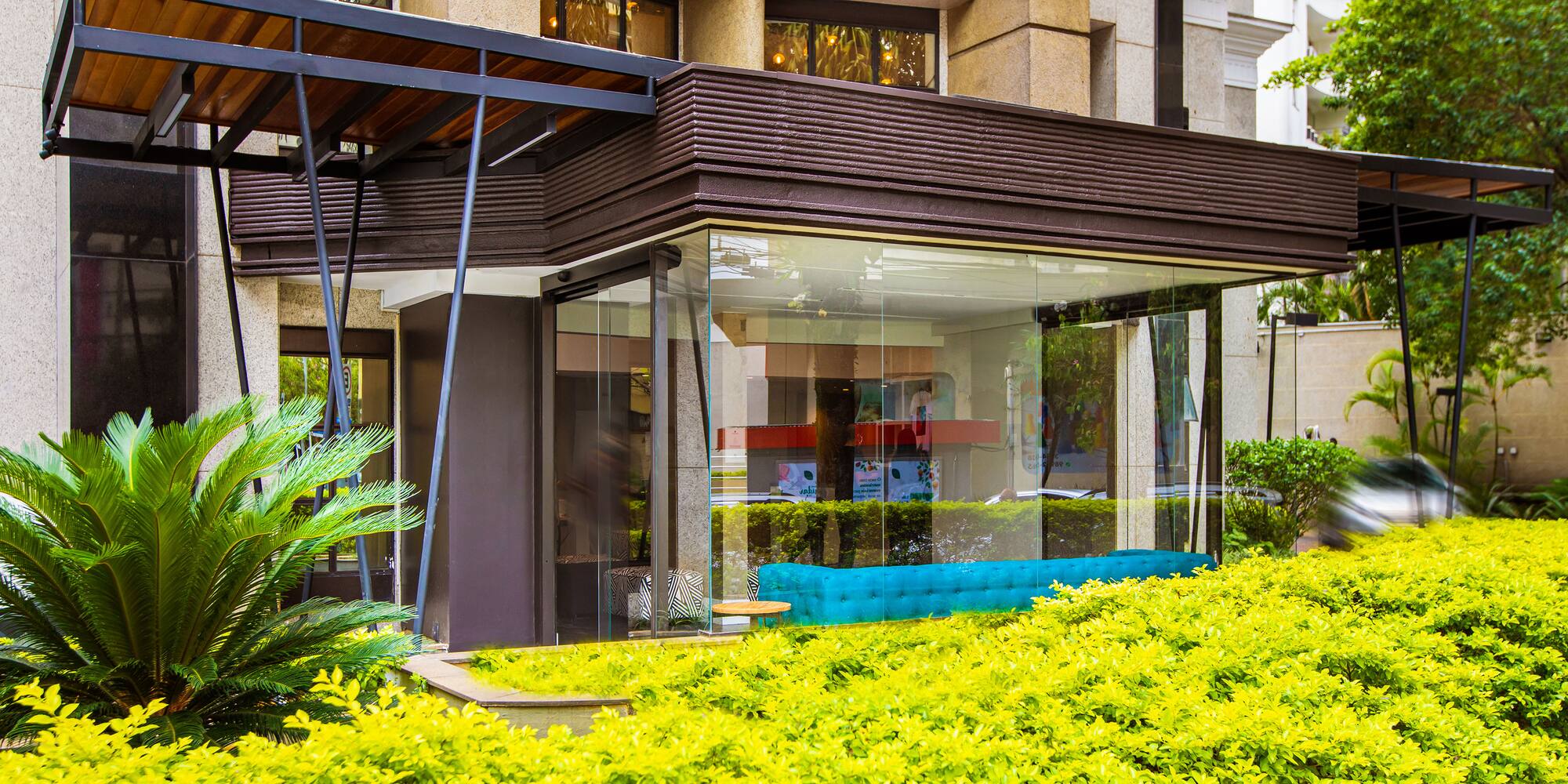 a building with a glass wall and a bench