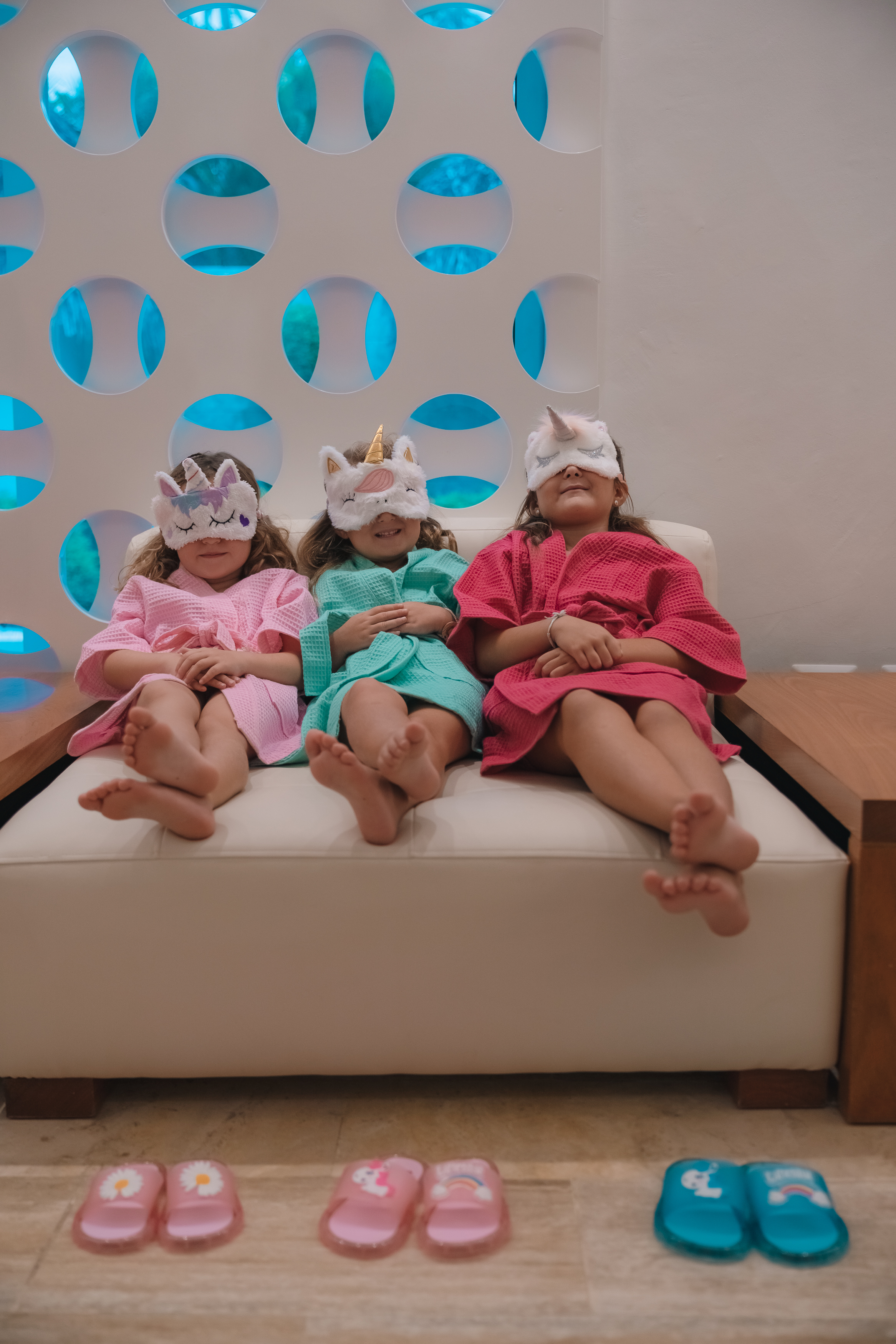 Kids spa day: Three girls in colorful robes and unicorn eye masks.