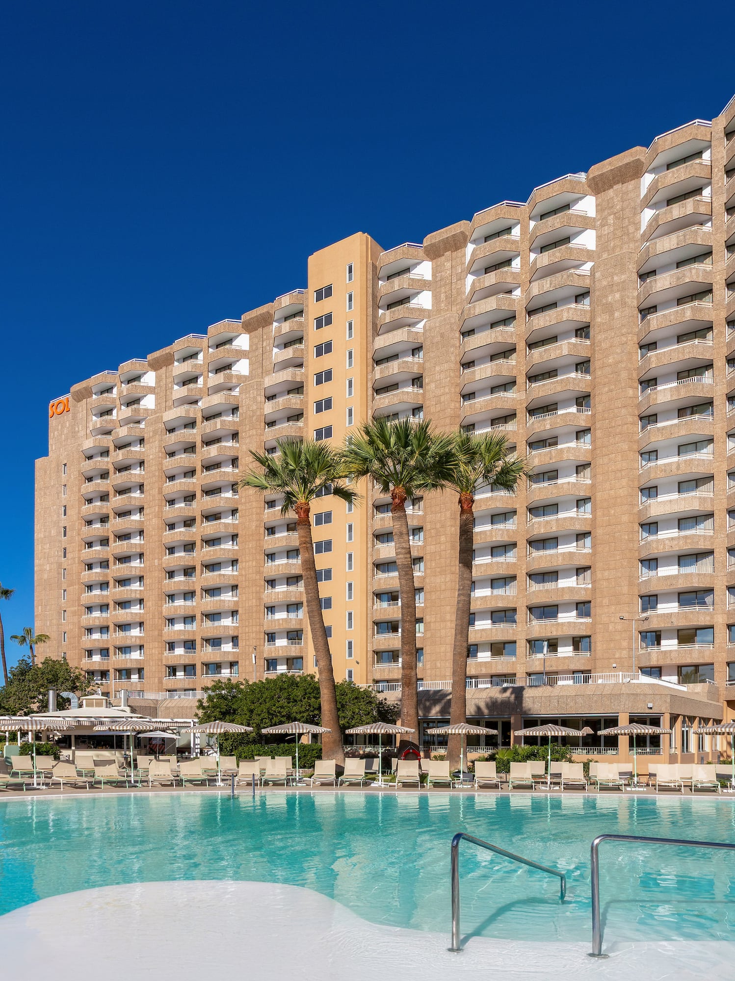 a large building with a pool in front of it