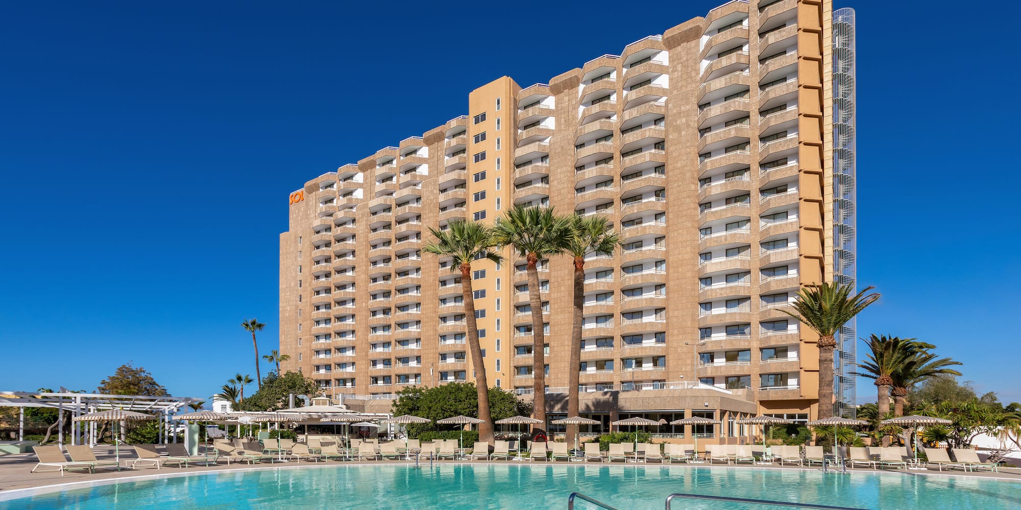a large building with a pool in front of it