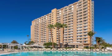 a large building with a pool in front of it