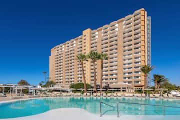 a large building with a pool in front of it