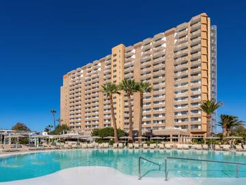 a large building with a pool in front of it