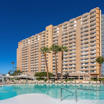 a large building with a pool in front of it
