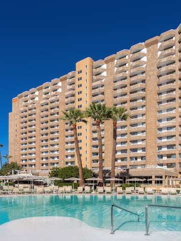 a large building with a pool in front of it