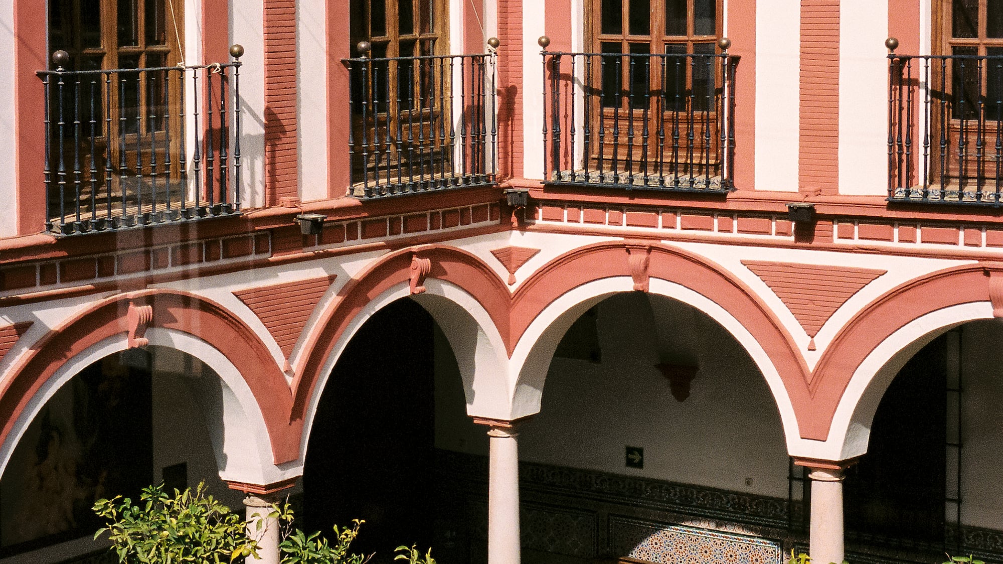 a building with a balcony and trees