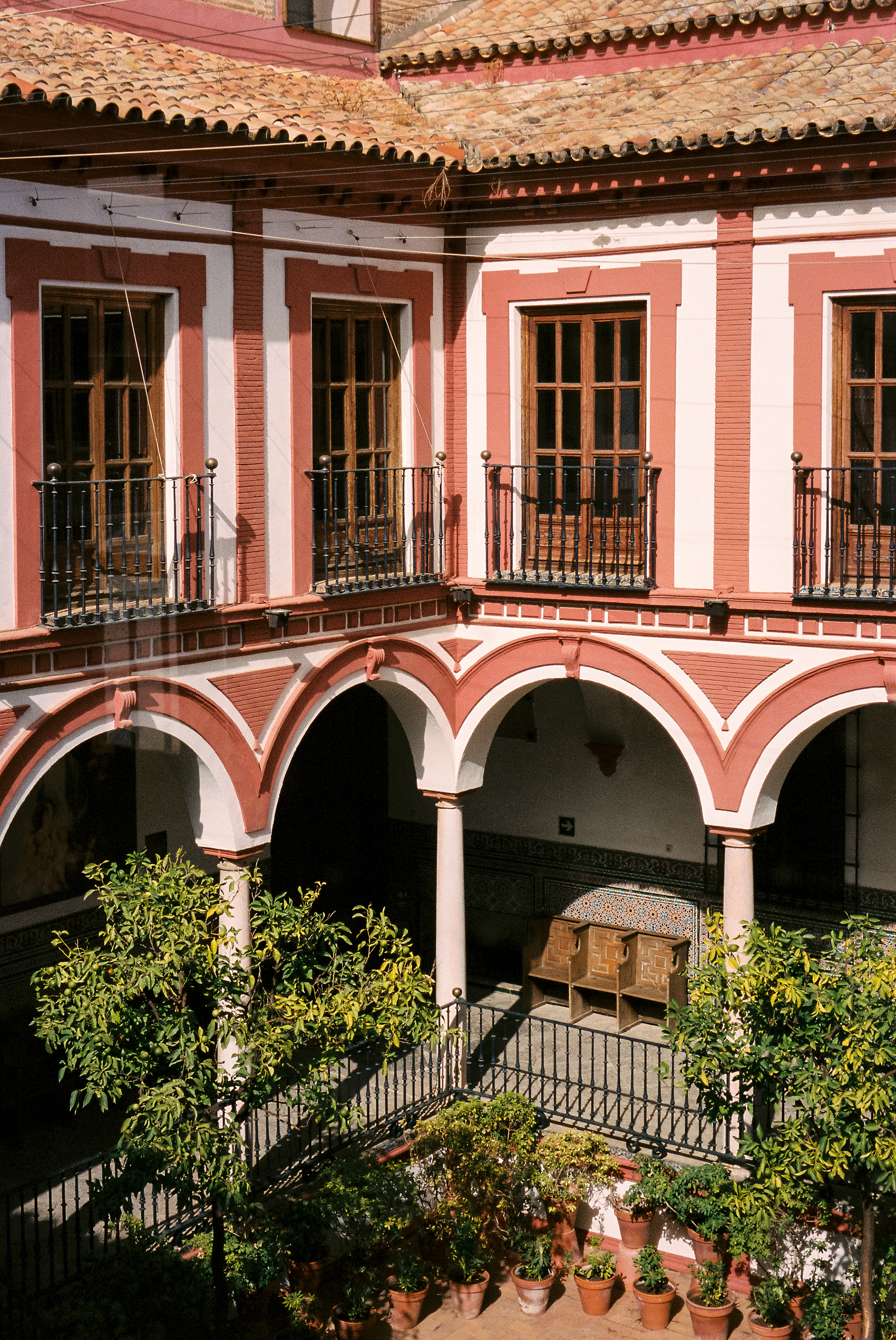 a building with a balcony and trees