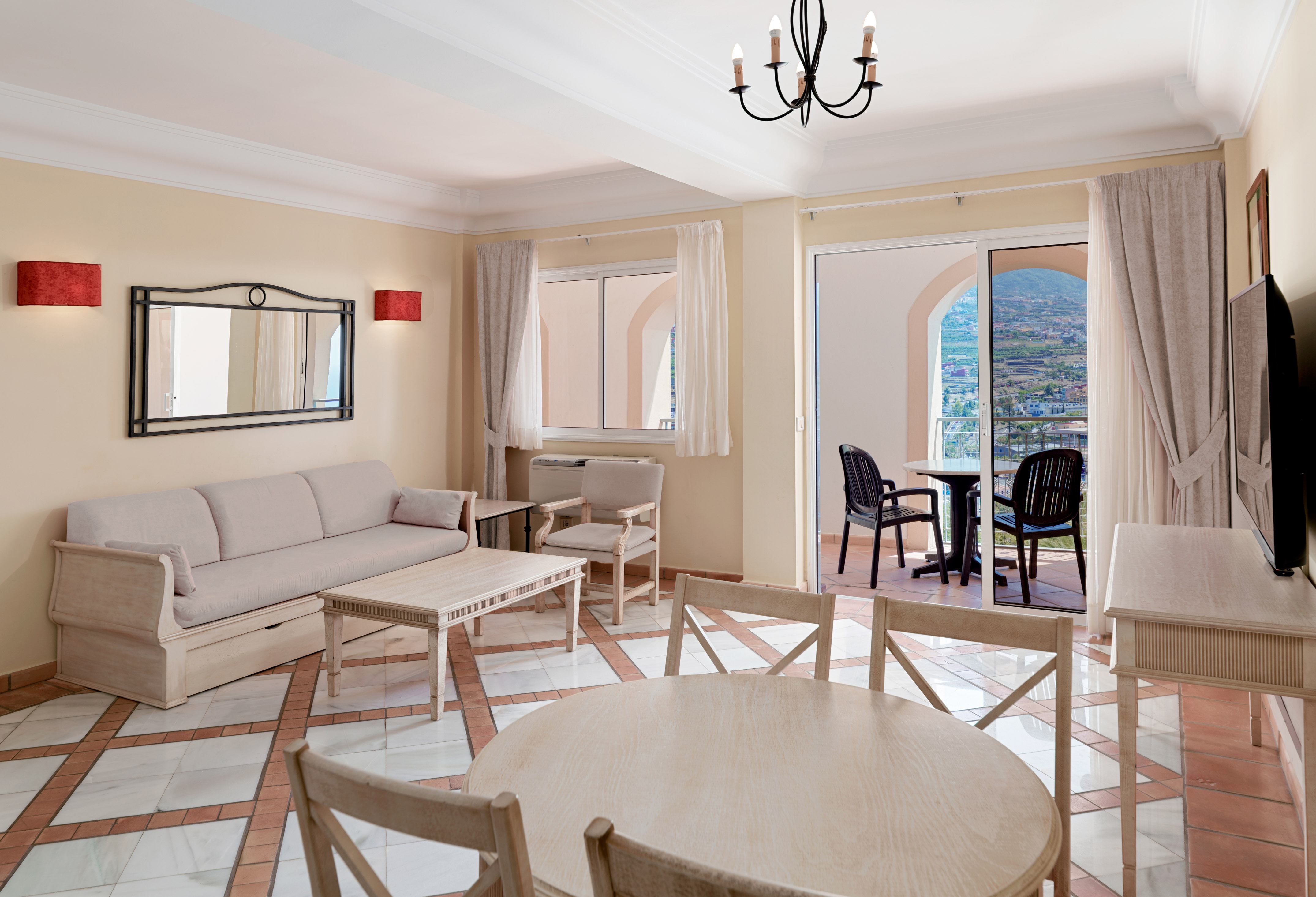 a living room with a table and chairs