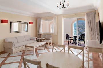 a living room with a table and chairs