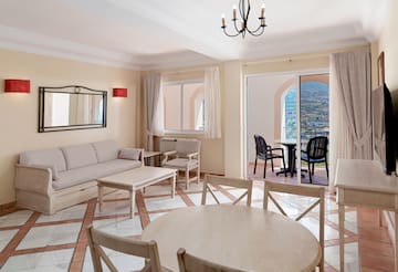 a living room with a table and chairs