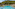 Resort swimming pool with sun loungers, straw umbrellas, and lush hillside.