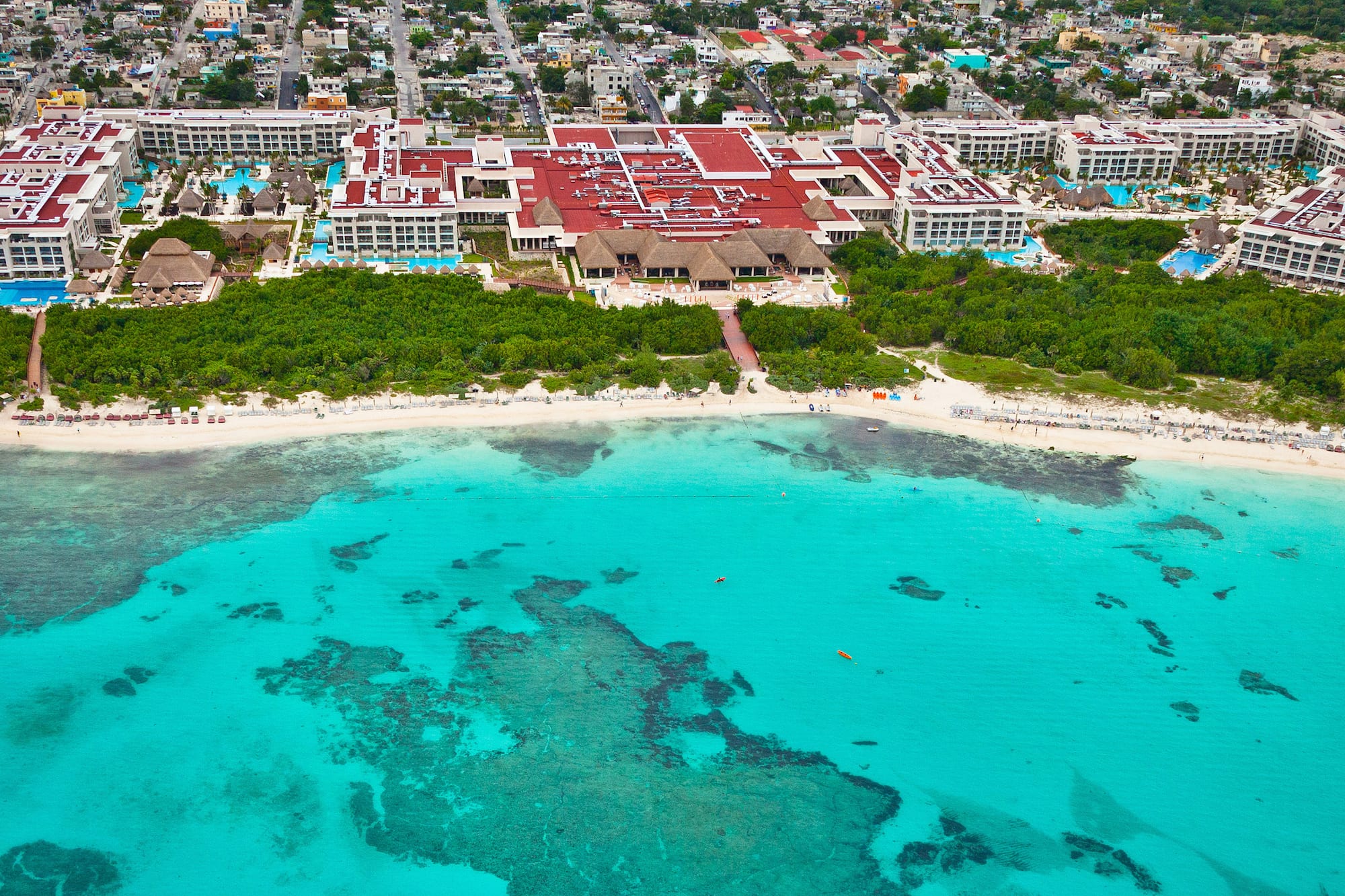 a beach with a building and trees