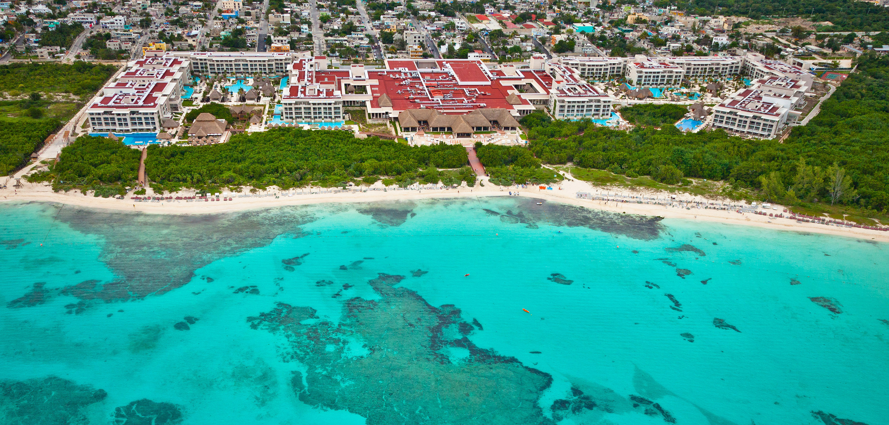a beach with a building and trees