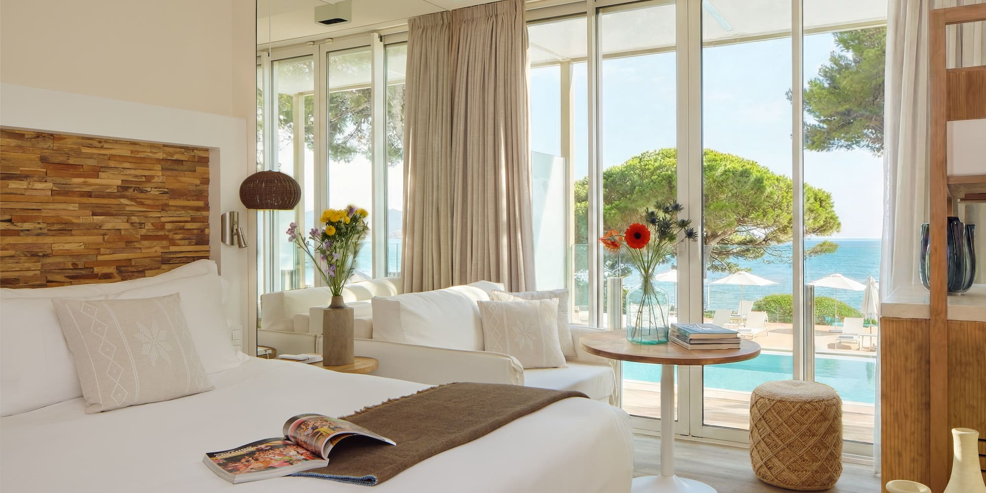 a room with a bed and a table and chairs