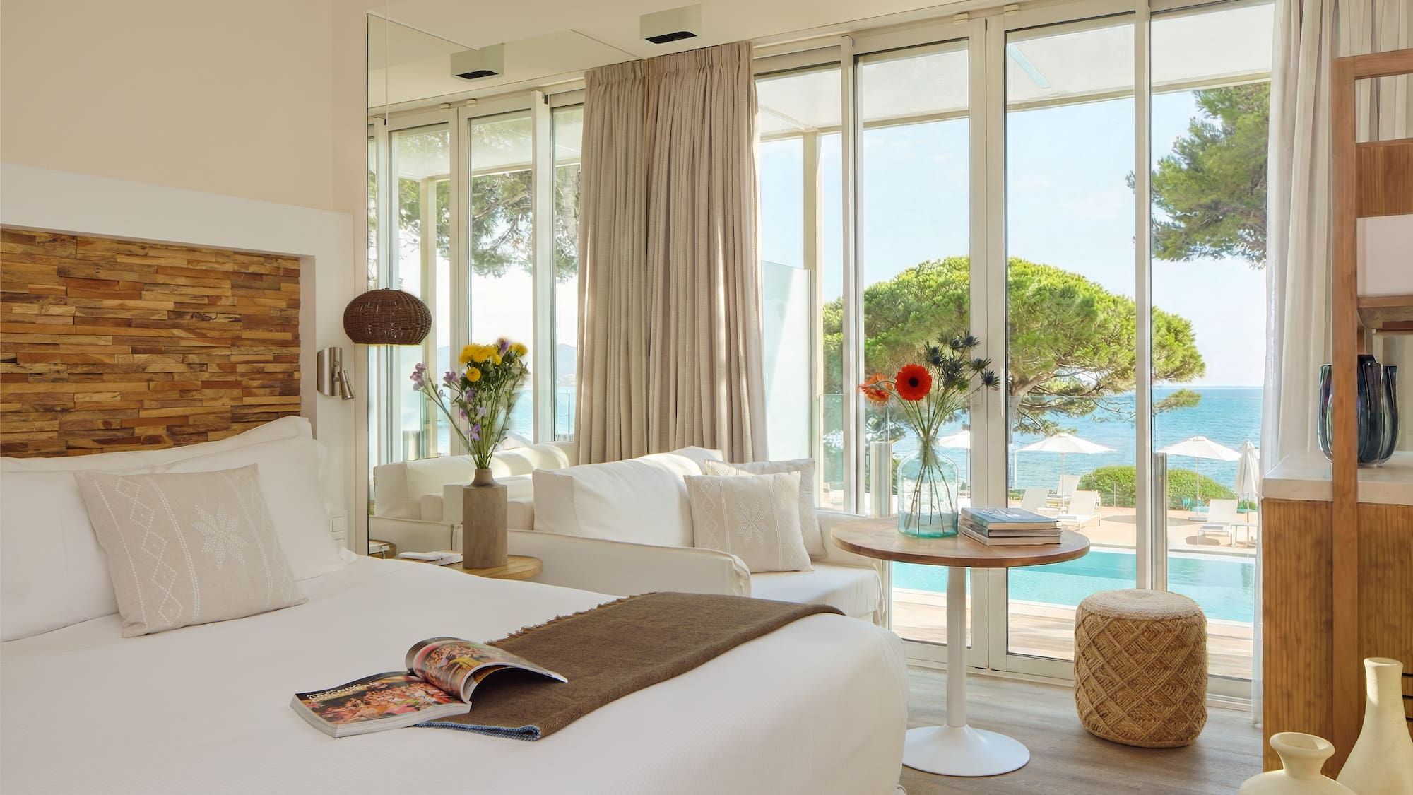 a room with a bed and a table and chairs