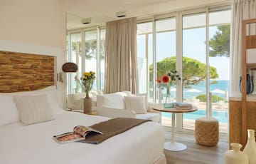 a room with a bed and a table and chairs