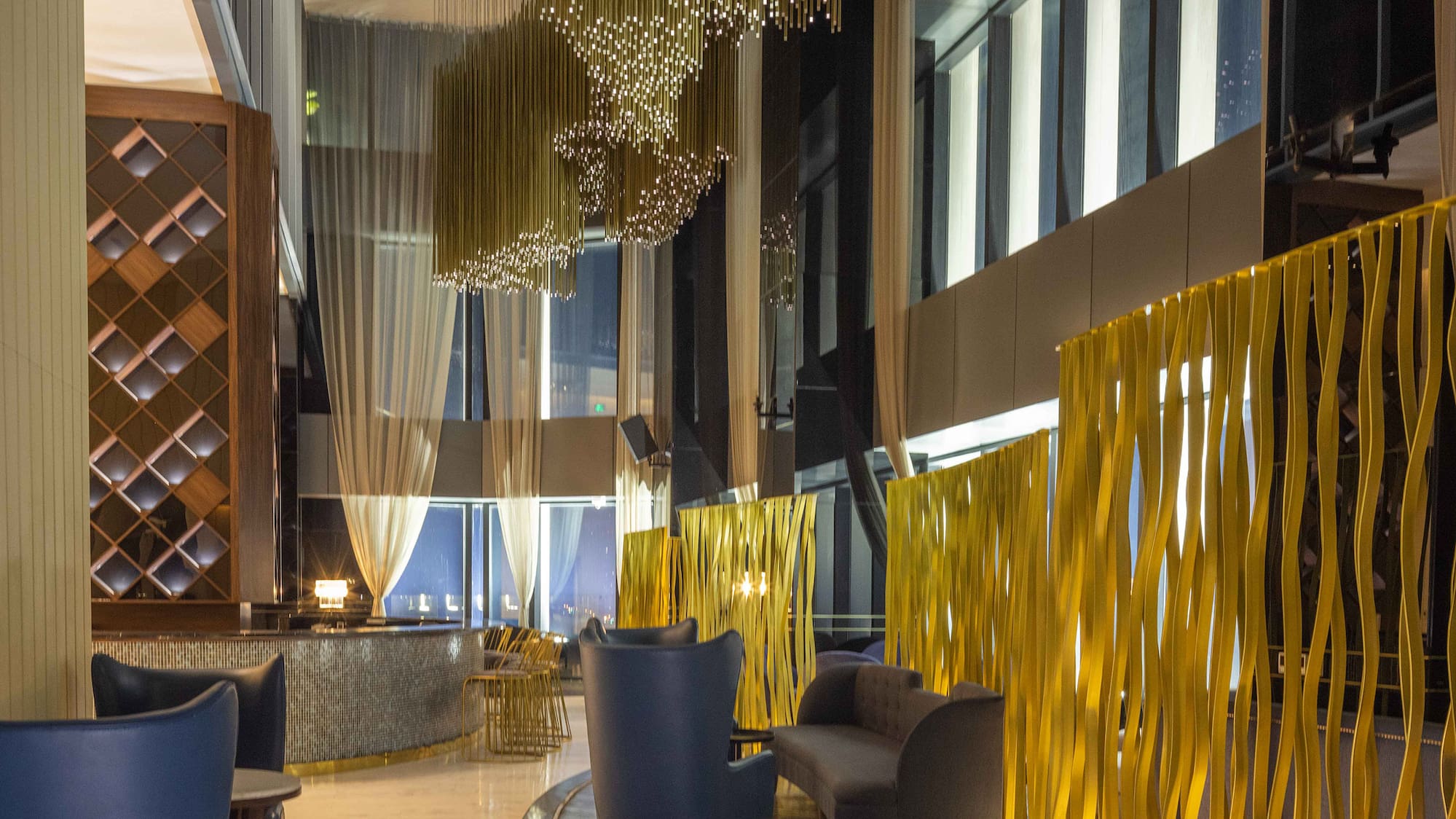 a room with a gold curtain wall and chairs
