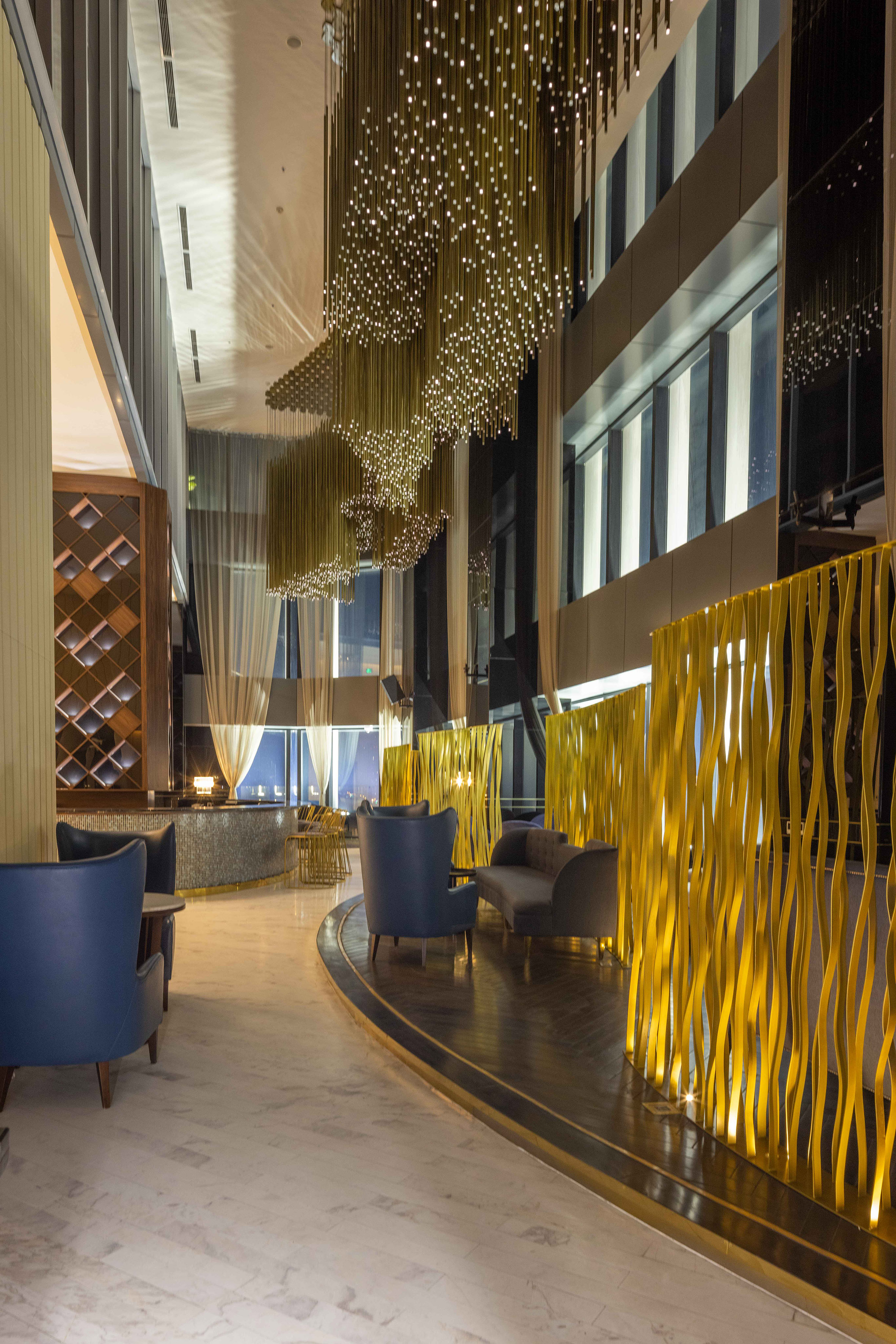 a room with a gold curtain wall and chairs