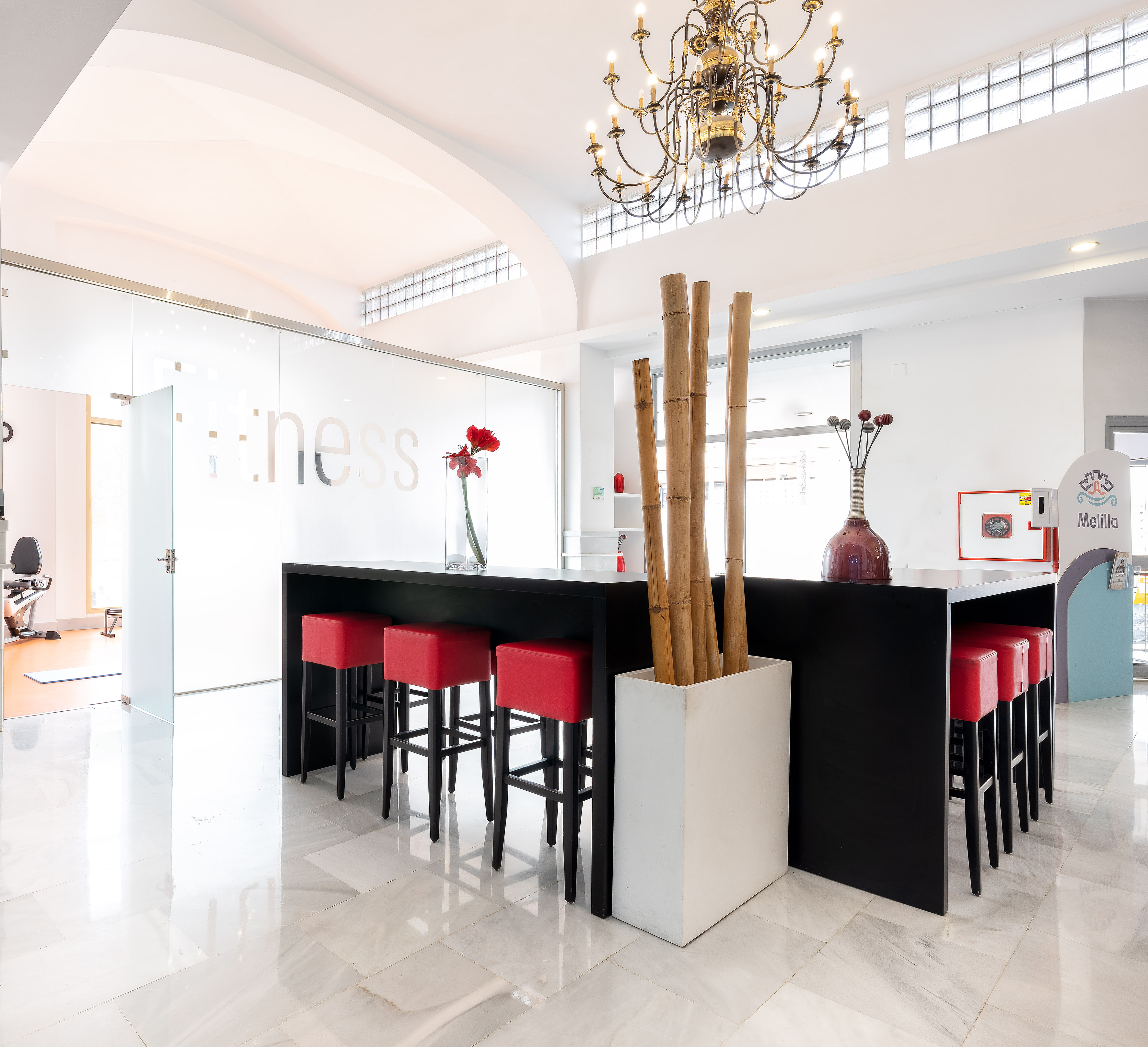 a room with a bar and a chandelier