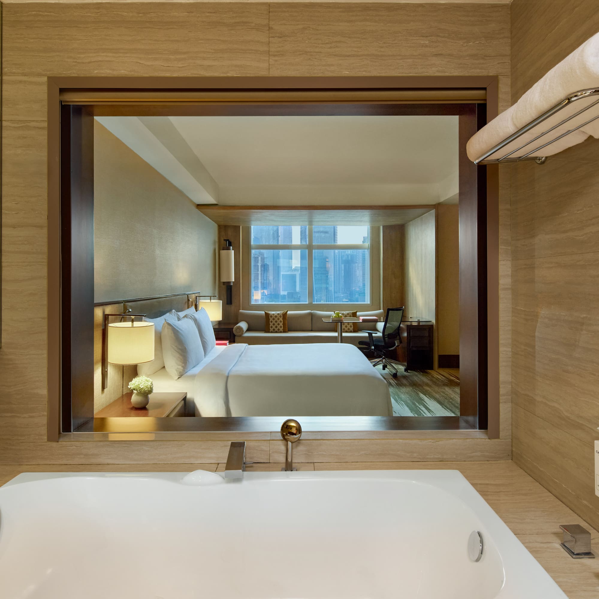 a bathroom with a window and a bed