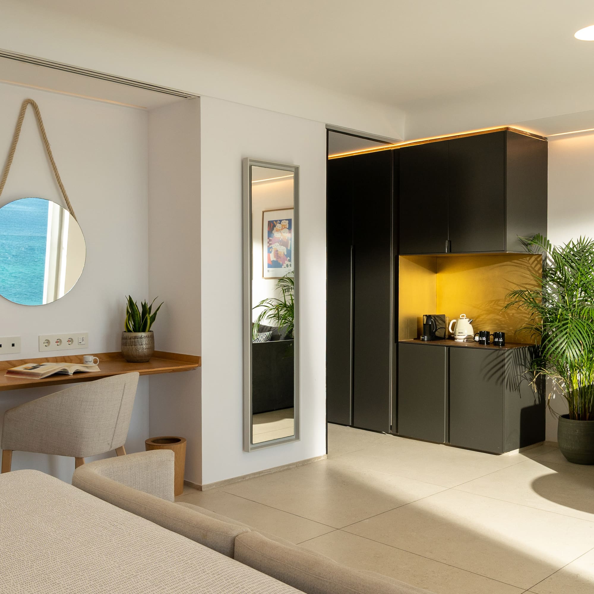 a room with a mirror and a table and plants