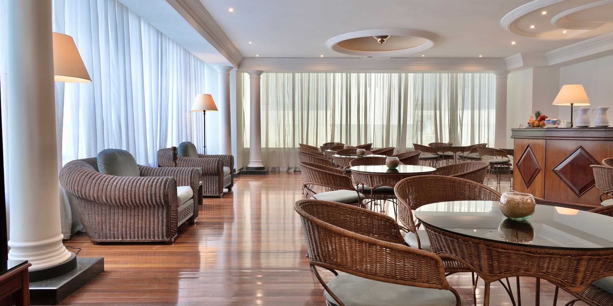 a room with wicker furniture and chairs