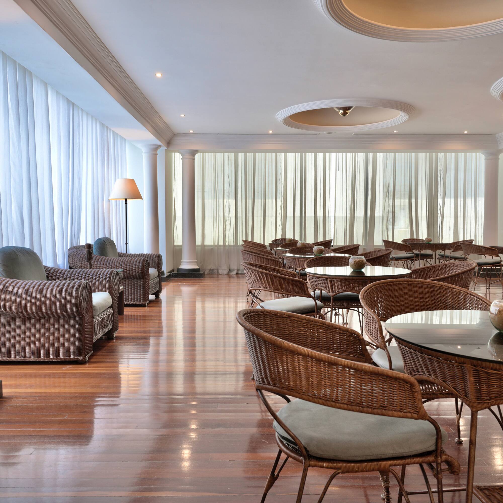 a room with wicker furniture and chairs