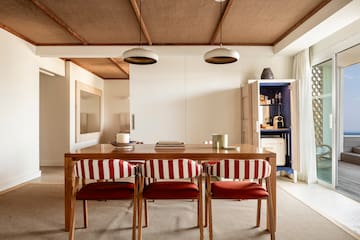 a dining table with chairs in a room
