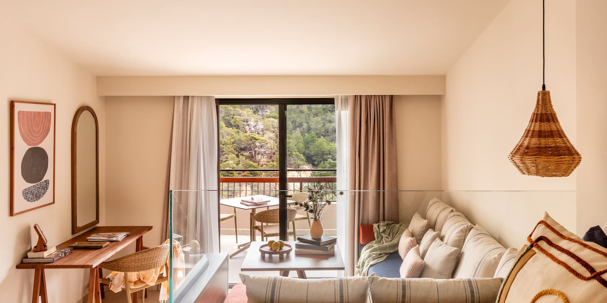 a living room with a glass railing and a couch