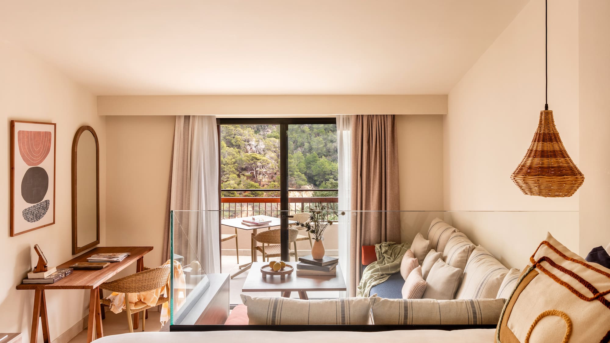 a living room with a glass railing and a couch