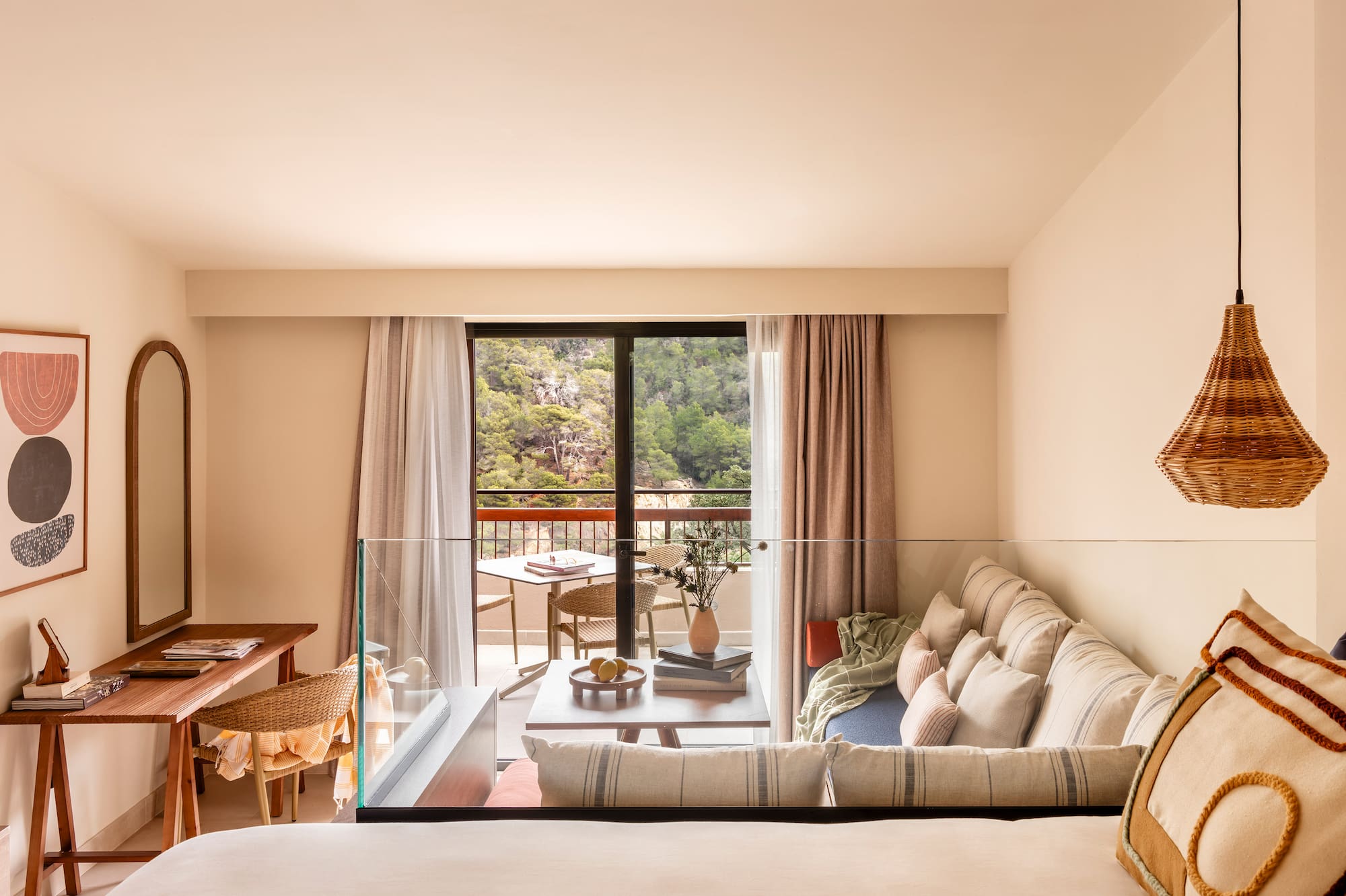 a living room with a glass railing and a couch