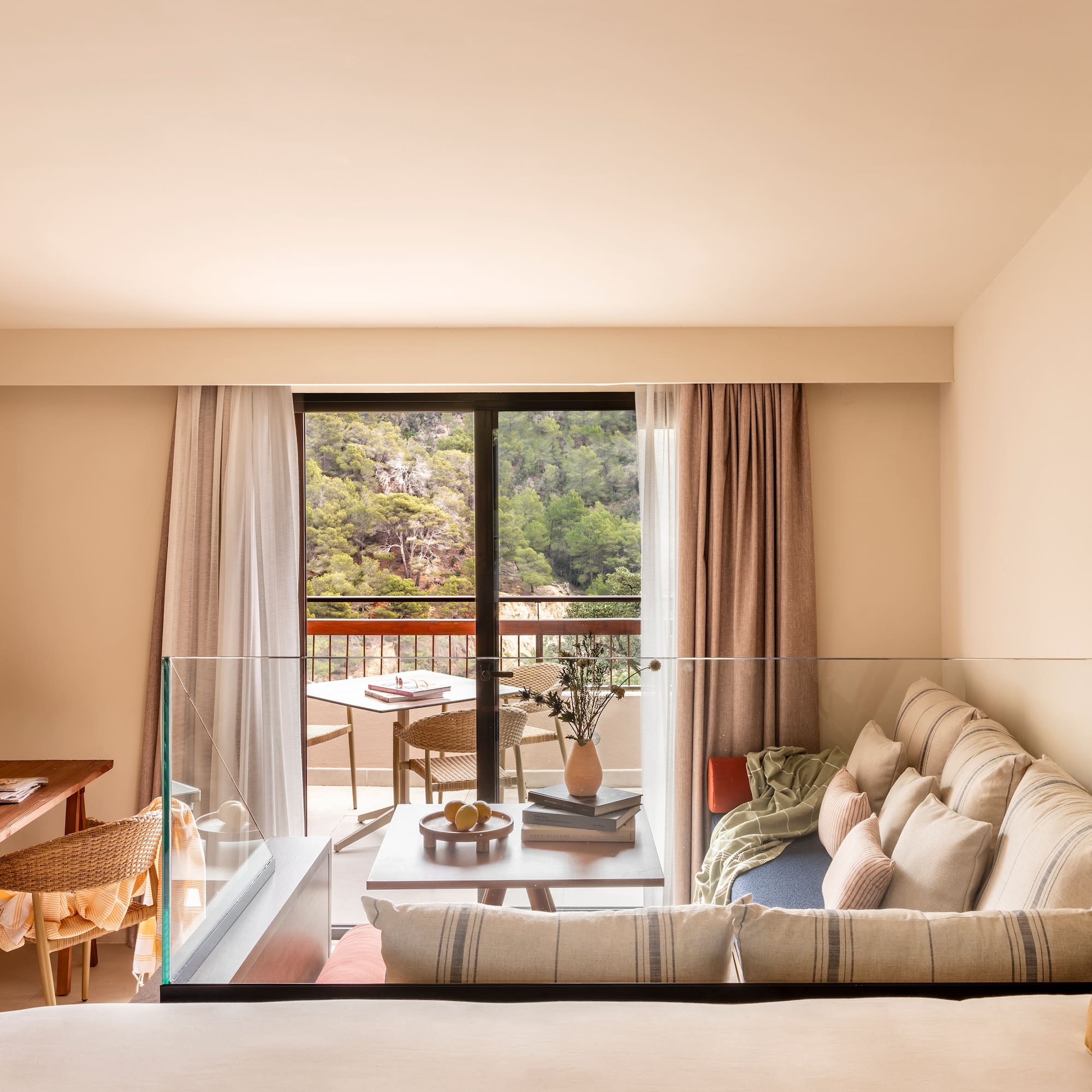 a living room with a glass railing and a couch