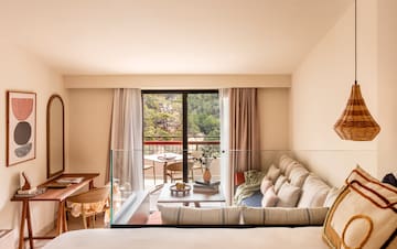 a living room with a glass railing and a couch