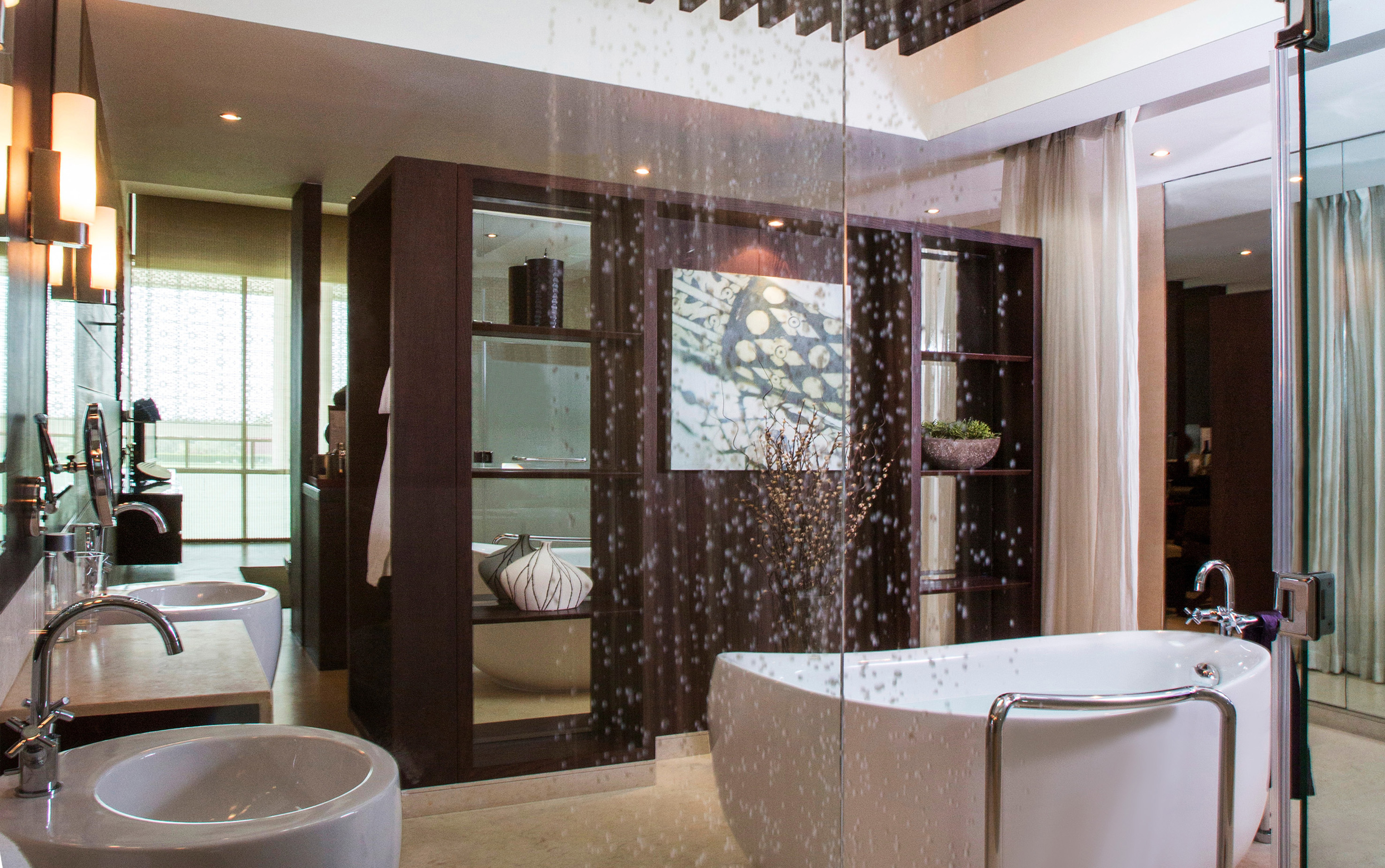Modern luxury bathroom with freestanding tub, glass shower, and double vanity.