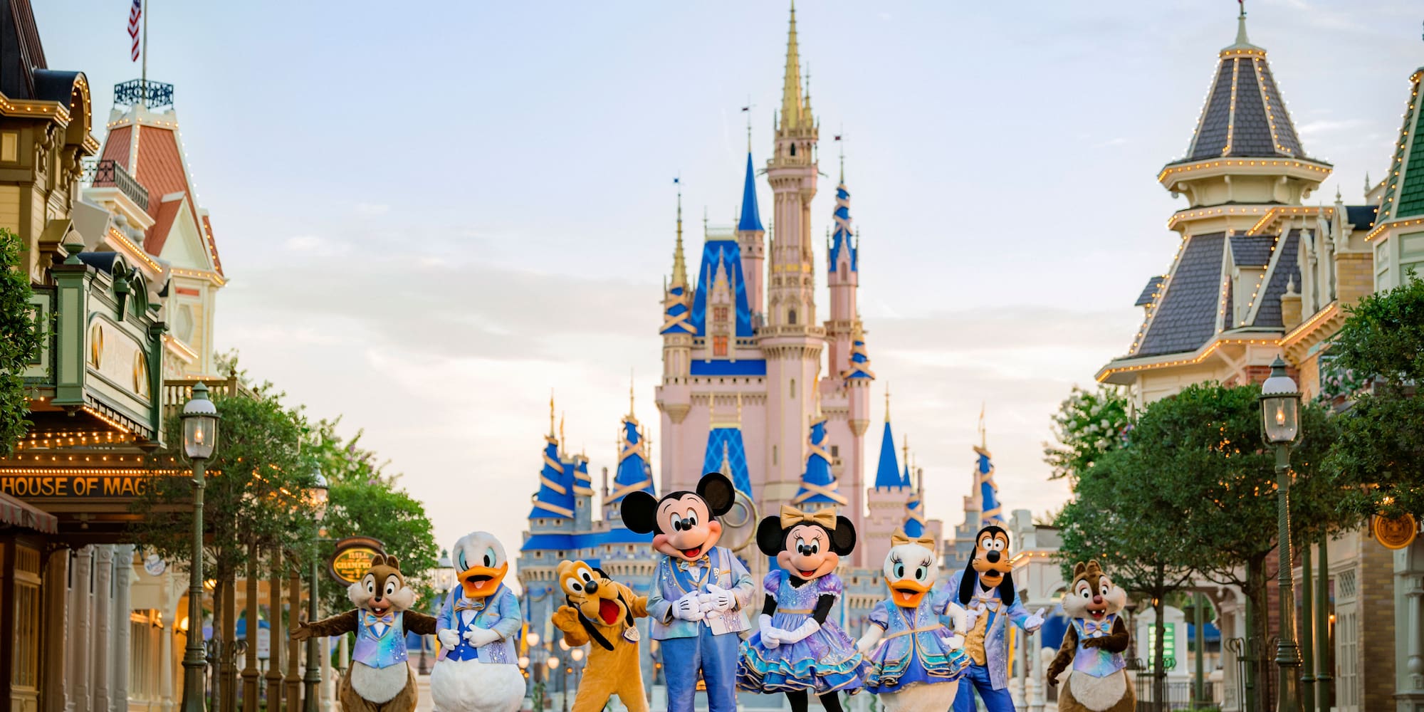 a group of people in clothing in front of a castle