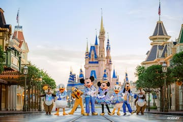 a group of people in clothing in front of a castle