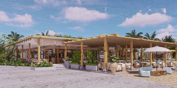 a building with a roof and chairs and a pool